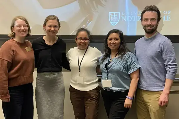 Five smiling people stand at the 2026 IMPACT WORKSHOP hosted by the LEO at the University of Notre Dame.