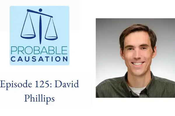 Probable Causation podcast logo with a balance scale. Text: Episode 125: David Phillips. To the right is a smiling David Phillips in a dark green shirt,