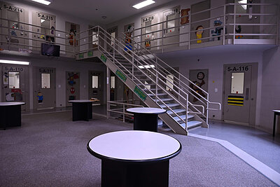 Inside the Lubbock County Detention Center. Rooms and stairs in a facility decorated with children's artwork and cartoon characters.